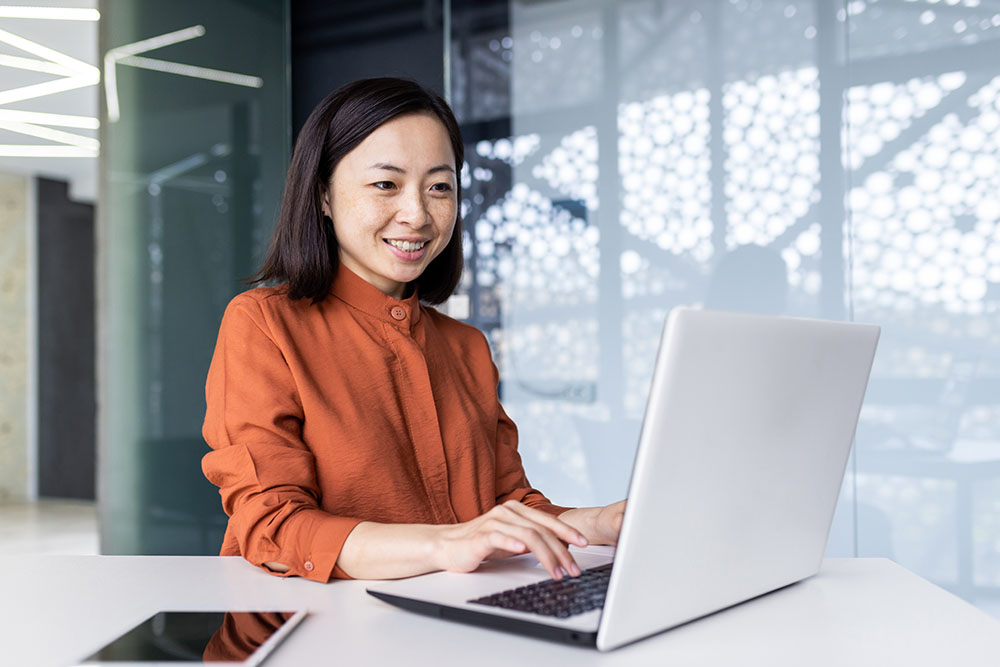 A small business owner accesses her business website on a laptop