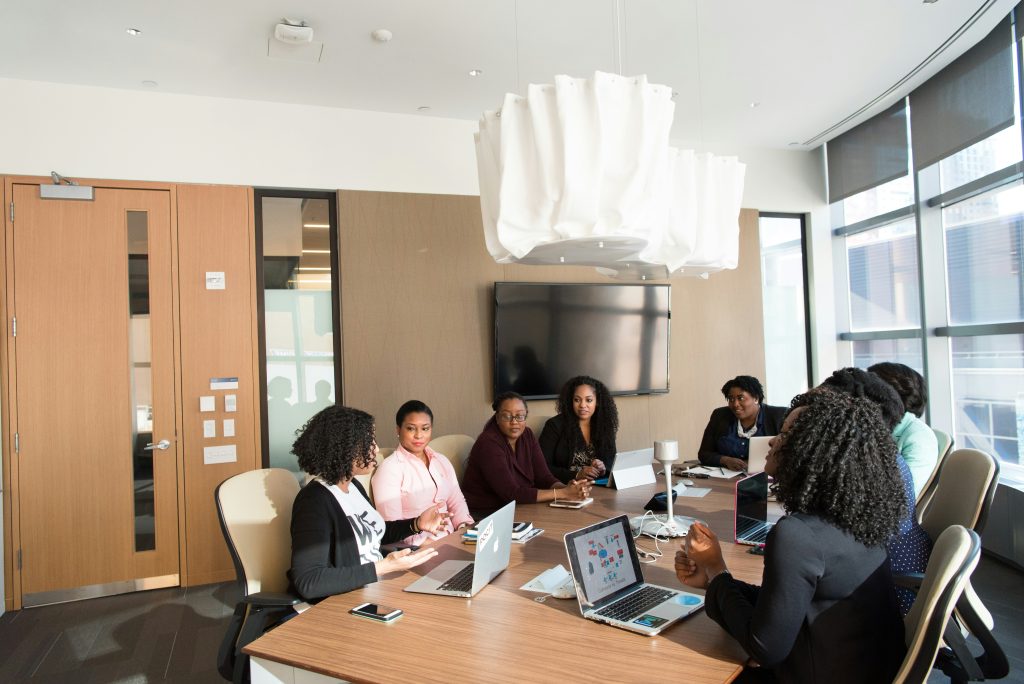 a group of small business attorney representatives sitting around a table with laptops